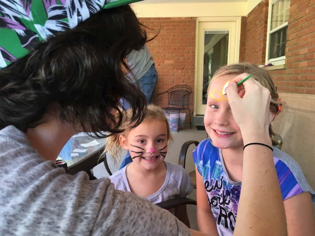 Take lots of bouncing friends, brush on some face paint, press on some tattoos, mix in a craft, eat lots of cupcakes and ice cream, and you end up with two very happy birthday girls!