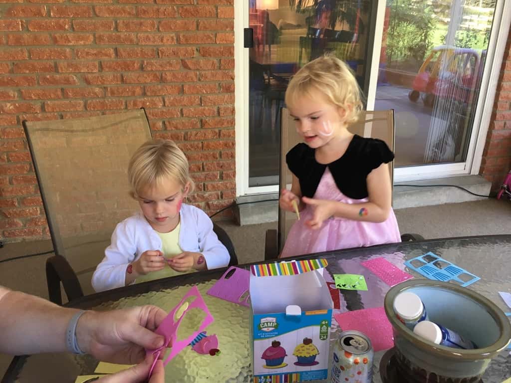 Take lots of bouncing friends, brush on some face paint, press on some tattoos, mix in a craft, eat lots of cupcakes and ice cream, and you end up with two very happy birthday girls!