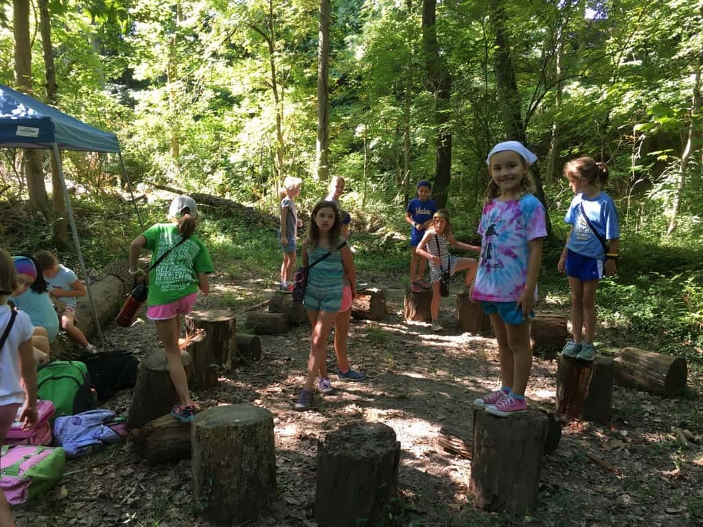 Girl Scout camp day 3 started off with our girls leading the rest of camp in the opening flag ceremony. After that, the day flew by with a talk about graphic design, cards for a service project, a nature scavenger hunt, sun s'mores, a group skit, a spider web craft, singing, creek time, hiking, and more!