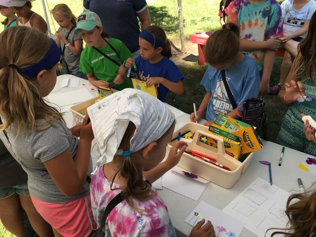 Girl Scout camp day 3 started off with our girls leading the rest of camp in the opening flag ceremony. After that, the day flew by with a talk about graphic design, cards for a service project, a nature scavenger hunt, sun s'mores, a group skit, a spider web craft, singing, creek time, hiking, and more!