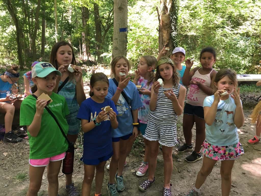 Girl Scout camp day 3 started off with our girls leading the rest of camp in the opening flag ceremony. After that, the day flew by with a talk about graphic design, cards for a service project, a nature scavenger hunt, sun s'mores, a group skit, a spider web craft, singing, creek time, hiking, and more!